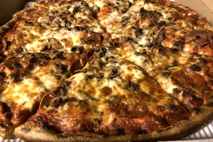 photo of pepperoni, mushroom, and hamburger pizza from New London Pizza, Concord, MA